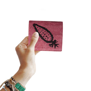 A woman holding a block printed pink cardholder wallet