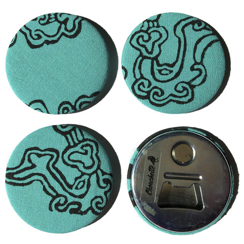 Four turquoise cloud magnet bottle openers, one showing the backside - Devrim Studio