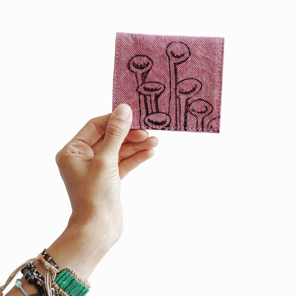 A woman holding a pink Stuck To The Floor cardholder, wallet - Devrim Studio
