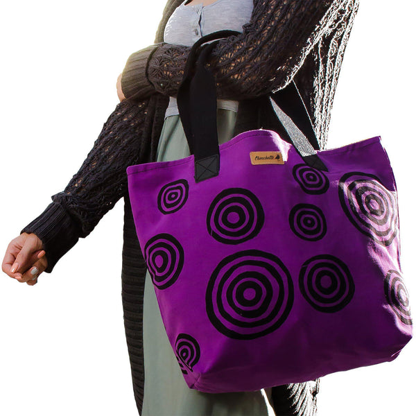 A woman holding a purple tote bag - Devrim Studio