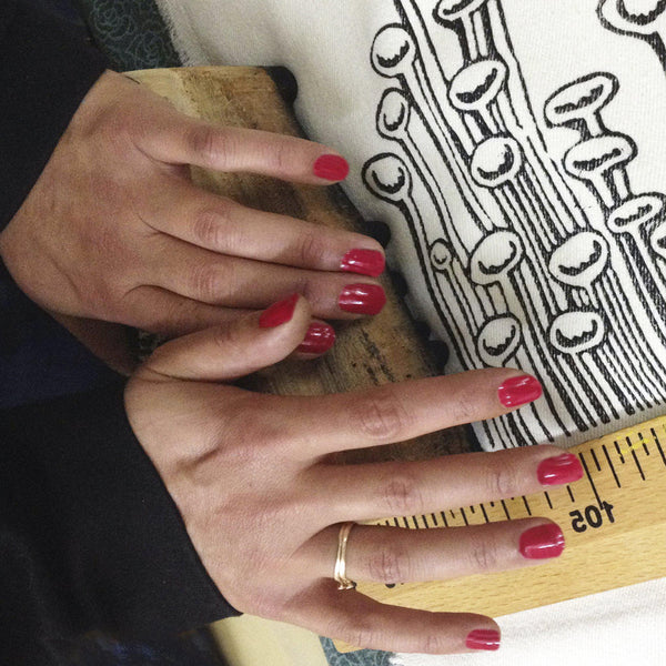 A woman block printing the artwork onto fabric - Devrim Studio