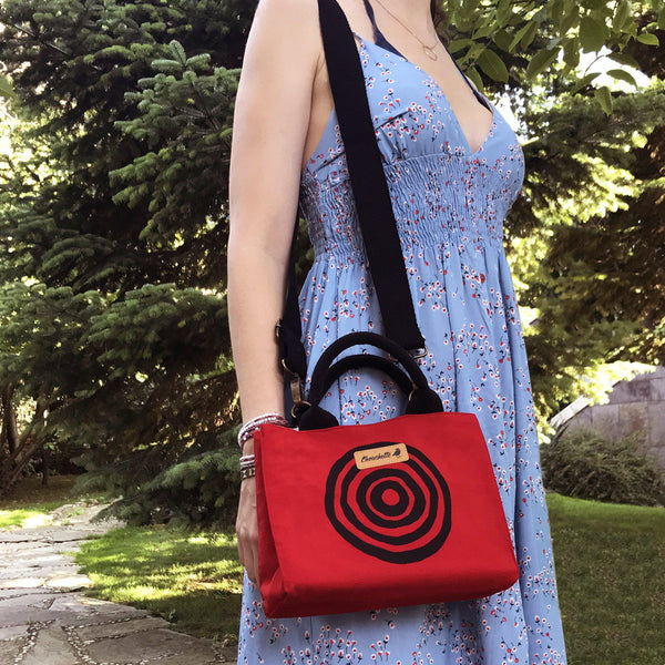 A woman wearing the red 'Time' Mini Tote Bag - Devrim Studio