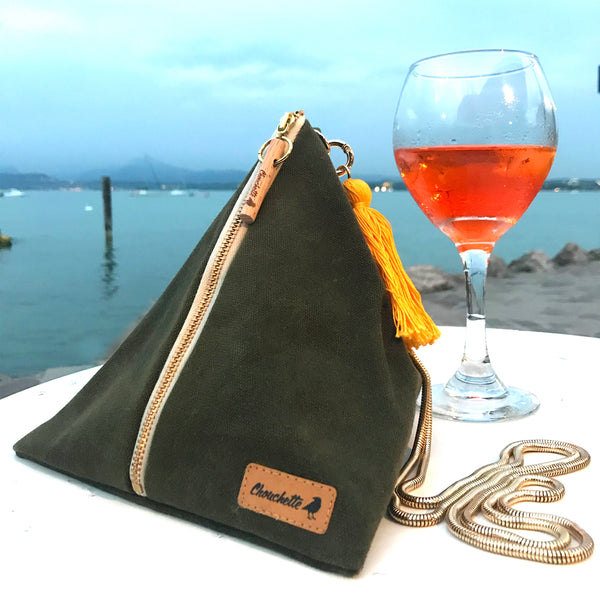 Waxed Canvas Ursula chain bag photographed on a table by the lake.